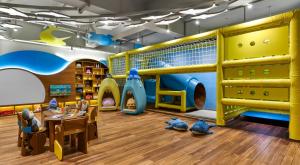 a childrens play room with a slide and play equipment at Holiday Inn Resort Bali Canggu by IHG in Canggu