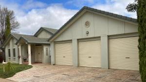 a house with two garage doors at HOME STAY on HIGH King Bed -- Private Home with Private Bathroom in Swan Hill +6 photos
