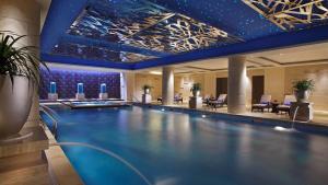 a swimming pool in a hotel lobby with a swimming pool at Lake View Hotel in Beijing
