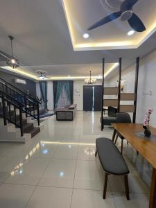 a living room with a ceiling fan and a table at D’Lora Homestay in Melaka