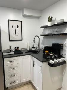 a kitchen with a sink and a coffee bar at Home away from Home in Ajax +6 photos