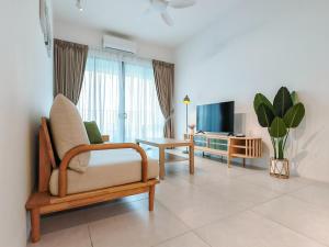 a living room with a chair and a television at Meritus - Perai, Penang in Perai