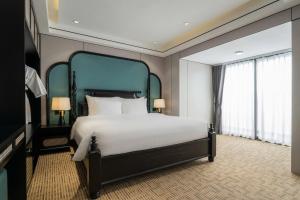 Postel nebo postele na pokoji v ubytování Hanoi International Hotel