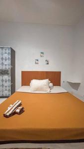 a bedroom with a bed with an orange bedspread at Conscioushouse 3BR near Seminyak up to 10pax in Legian