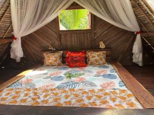 a bed in a tent with a window at Les Lodges de La Buvette ÉCO LODGE RESTAURANT in Ile aux Nattes +140 photos