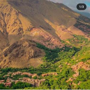 a view of a mountain with a town in front at Treks in imlil in Imlil