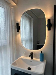 a bathroom with a sink and a mirror at Abbey House B & B in Penrith +54 photos