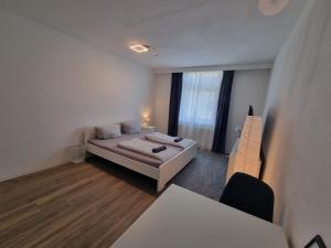a white room with a bed and a table at Süße Marie 9 in Karlsruhe