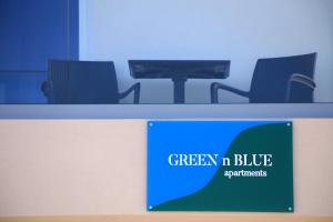 a desk with a sign that reads green n blue supplements at GREEN n' BLUE apartments in Kalamaki