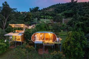 a house that is sitting in a field at ดาริน โฮมสเตย์ in Ban Thung Phan Ha