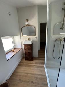 a bathroom with a sink and a mirror at Maison de famille in Trélissac +14 photos