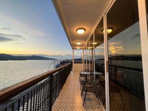 a balcony with chairs and tables on a cruise ship at Casa Der See Boutique House in Songkhla