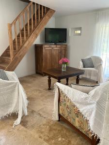 a living room with a table and a tv at Maison de famille in Trélissac