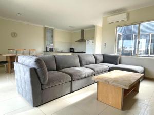 a living room with a couch and a table at Unit 27 Seafront Estate in Jurien Bay