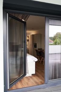 a room with a sliding glass door leading to a bedroom at Calm Apart in Kleinkötz