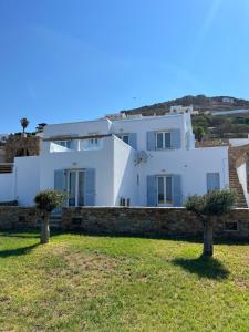 a white house with two trees in front of it at Galazio in Naxos Chora