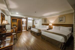 Postel nebo postele na pokoji v ubytování Villa Caceres Hotel