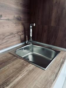 a kitchen sink with a faucet on a counter at Sunny Coast in Dobra Voda +26 photos