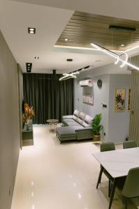 a living room with a couch and chairs and tables at Trival Misty Cottage Homestay Sri Indah Sandakan in Sandakan