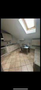 a kitchen with a skylight and a couch and a table at Appartamento cherasco in Cherasco