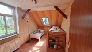 a small room with a bed and a window at Klinkerhaus Treuen in Treuen