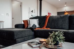 a living room with a couch and a table at Hobart Luxury Family Home with Spa & Fire Pit, Sleeps 8 in Sorell