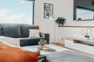 a living room with a couch and a table at Hobart Luxury Family Home with Spa & Fire Pit, Sleeps 8 in Sorell
