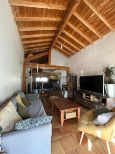 a living room with a couch and a table at Maison PAU - BIZANOS in Bizanos