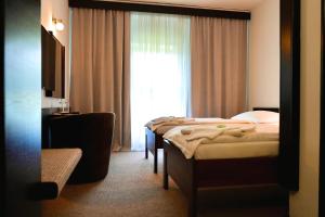 Ένα ή περισσότερα κρεβάτια σε δωμάτιο στο Hotel Merkur - Jablonec nad Nisou