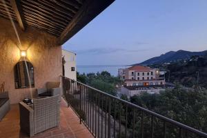 a balcony with a view of a building at Maison bord de mer - piscine - in Théoule-sur-Mer