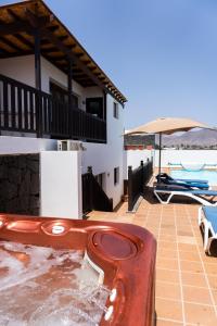 a house with a hot tub on a patio at CASA PARI in Playa Blanca
