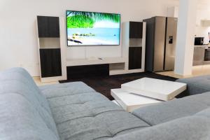 a living room with a couch and a flat screen tv at CASA PARI in Playa Blanca