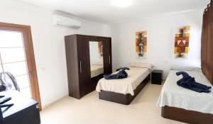 a bedroom with two beds and a mirror in it at CASA PARI in Playa Blanca +53 photos