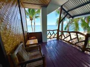 a room with a balcony with a view of the ocean at White Knight Double Family Room in San Juan