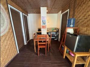 a dining room with a table and a refrigerator at White Knight Double Family Room in San Juan