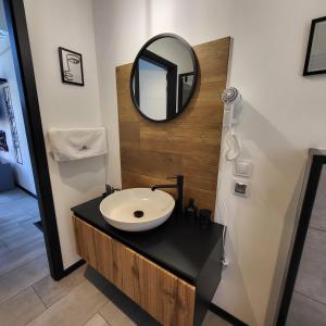 a bathroom with a sink and a mirror on a counter at Baltic Barns Berg in Wytowno +16 photos