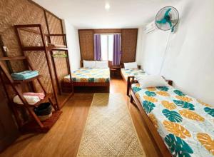 a room with two beds and a bunk bed at White Knight Double Family Room in San Juan