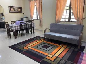 a living room with a couch and a table at Faris's Homestay & Resort in Pasir Puteh