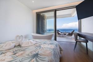 a bedroom with a bed with a view of the ocean at Villa Romana - Luxury Estate in Stomorska +65 photos
