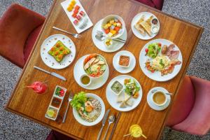 a wooden table with plates of food on it at Viroth's Hotel in Siem Reap