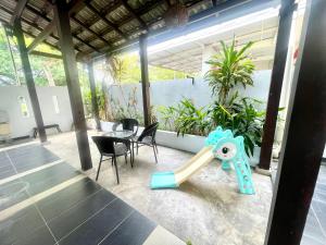 a childs toy on the patio of a house at Comfort 36 Entire House At Alma Bukit Mertajam in Bukit Mertajam