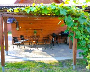 a patio with a table and chairs under a pergola at Pokoje gościnne Zawoja Centrum Henryk Hadka in Zawoja