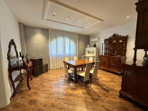 a dining room with a wooden table and chairs at All'ombra della magnolia in Selvazzano Dentro
