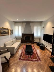 a living room with a couch and a fireplace at All'ombra della magnolia in Selvazzano Dentro