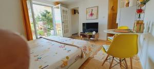 a room with a bed and a table and a table at Lovely place with a view of Skopje in Skopje