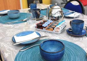 a table with blue plates and blue cups on it at Cairnview Bed and Breakfast in Larne