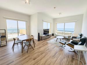 a living room with a view of the ocean at Bab Al Bahr Residence - Blue Collection Holiday Homes in Ras al Khaimah