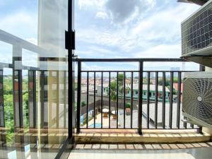a balcony with a view of a city at Comfort 2BR at 6th Floor Metropark Condominium Jababeka Apartment By Travelio in Cikarang