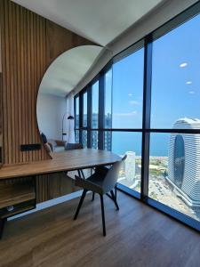 a dining room with a table and a mirror at Sea View Plaza Batumi Centre in Batumi