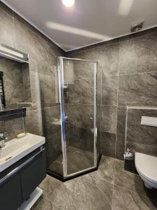 a bathroom with a shower and a sink at Sea View Plaza Batumi Centre in Batumi
